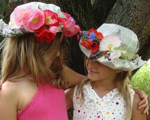 Sombreros de papel de periódico y flores